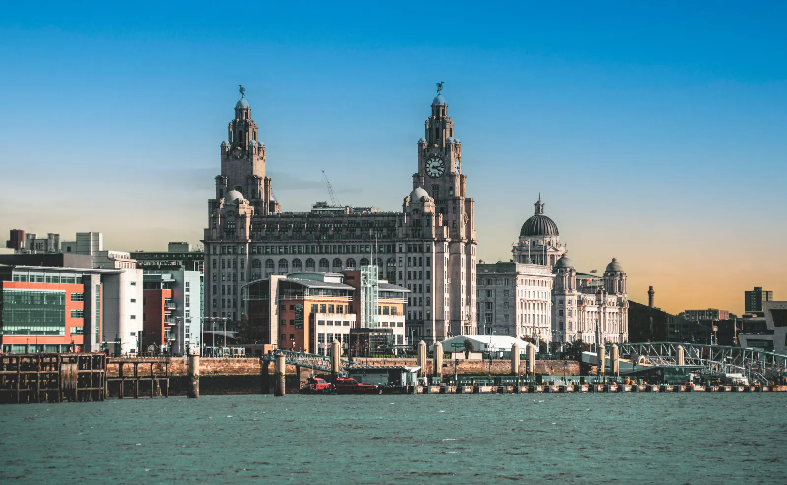 A city waterfront skyline with historic buildings across the river