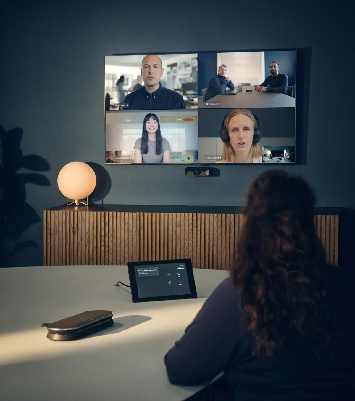 A video call on a meeting-room screen
